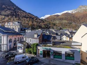a small town with a mountain in the background at Spacieux T2 centre ville avec WIFI et équipements sportifs - FR-1-401-274 in Cauterets