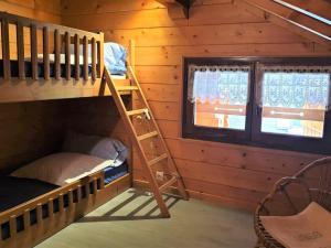 a bunk bed and ladder in a cabin with a window at Chalet Morzine, 3 pièces, 5 personnes - FR-1-754-77 in Morzine