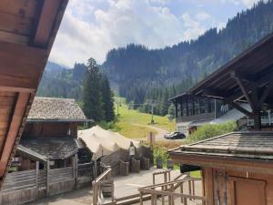 a view of a building with a tent in the background at Chalet Morzine, 3 pièces, 5 personnes - FR-1-754-77 in Morzine
