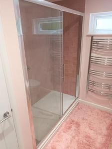 a shower with a glass door in a bathroom at Paradise in the Oxfordshire Cotswolds in Epwell