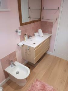 a bathroom with a sink and a toilet and a mirror at Paradise in the Oxfordshire Cotswolds in Epwell