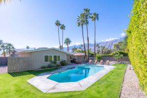 einen Hinterhof mit einem Pool und einem Haus in der Unterkunft Sunrise Park Oasis in Palm Springs