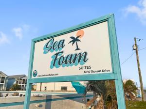 a sign for a sea foam tennis clinic at Sea Foam Suites in Panama City Beach