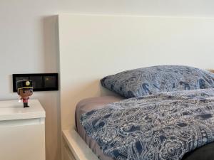 a bedroom with a bed with a blue and white comforter at Old Town Nadmotławie - Sauna & Gym I 10min deptak in Gdańsk