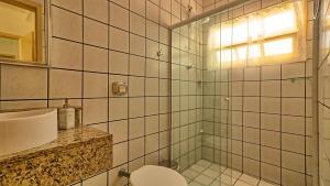 a bathroom with a shower and a toilet and a sink at #018 Casa 2 minutos a pé da Praia de Palmas in Governador Celso Ramos +29 photos