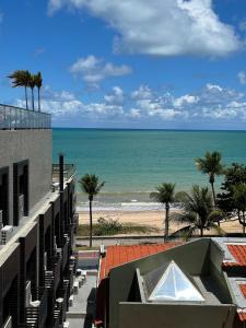 a view of the beach from the balcony of a building at Arpoar Suítes by Day by Day in João Pessoa