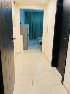 a hallway of a hospital room with a hallway at Cozy and Spacious Studio in Dubai