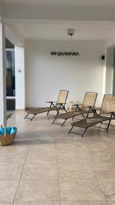 a group of chairs lined up in a room at QHAWANA CABAÑAS & SUITES in La Rioja