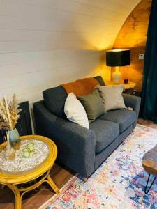 a living room with a blue couch and a table at Clyde Croft - (Luxury Cabin) in Portpatrick