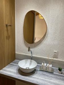 a bathroom with a bowl sink and a mirror at Noronheiro Boutique & House in Fernando de Noronha +48 photos