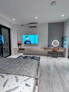 a bedroom with a bed and a flat screen tv at Homestay Pháo Đài Láng in Hanoi