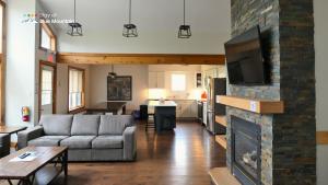 a living room with a couch and a fireplace at Summit Ridge 2 in Blue Mountains