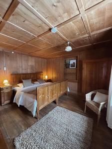 a bedroom with a bed and a wooden ceiling at Ferienhaus Alpenglück in Wenns