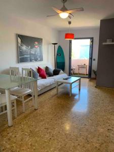 a living room with a couch and a glass table at APARTAMENTO PLAYA URB PRIVADA 2 Habitaciones in Valencia