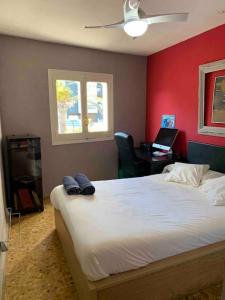 a bedroom with a large bed with a red wall at APARTAMENTO PLAYA URB PRIVADA 2 Habitaciones in Valencia