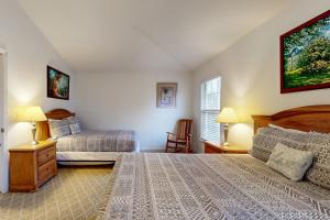 Bon TerraSpacious townhome with shared pool near golf, marinas, & restaurants的一间卧室，有两张床、两盏灯和一扇窗户 更多24张照片