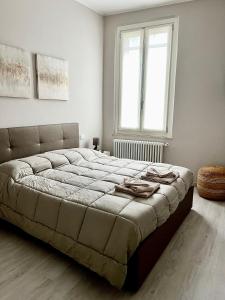 a bedroom with a large bed and a window at Maison del Ducato Suite Correggio in Parma