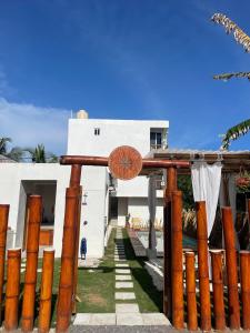 a house with a wooden gate in front of it at Wander Boutique Hotel in El Paredón Buena Vista