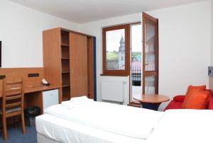 Letto o letti in una camera di Hotelový dům Kaskáda - Bed and Breakfast