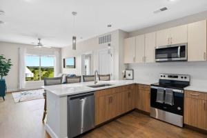 a kitchen with a sink and a stove at Beverly Hills Suite Penthouse The Gulch in Nashville