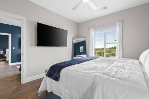 een slaapkamer met een groot bed en een flatscreen-tv bij Beverly Hills Suite Penthouse The Gulch in Nashville