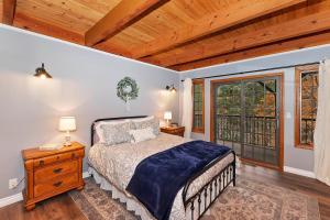 a bedroom with a bed and a large window at 140 - Kaisers Cozy Cabin in Big Bear Lake