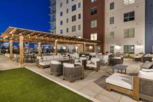 a patio at a hotel with tables and chairs at Beverly Hills Suite Penthouse The Gulch in Nashville