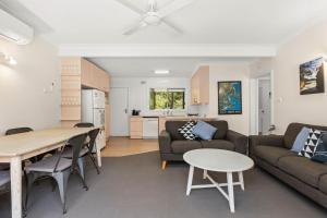 a living room with a couch and a table at Rocks Place by Experience Jervis Bay in Vincentia