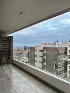 a balcony with a view of a large building at Elegante apto, auto check-in, parking gratis. in Antofagasta