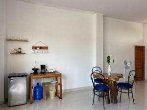 a living room with a table and chairs and a wall at habitación cerca a playa man in San Cristobal