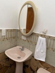 a bathroom with a sink and a mirror at habitación cerca a playa man in San Cristobal