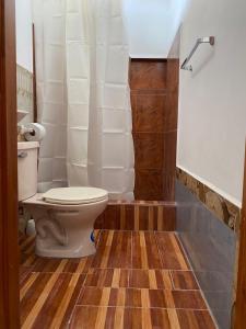 a bathroom with a toilet and a shower at habitación cerca a playa man in San Cristobal