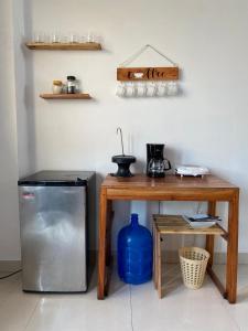a kitchen with a small table and a refrigerator at habitación cerca a playa man in San Cristobal