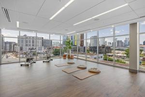 a gym with several exercise bikes in a room with windows at Beverly Hills Suite Penthouse The Gulch in Nashville