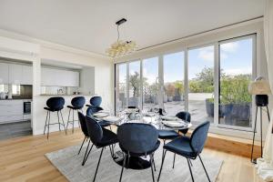 a kitchen and dining room with a table and chairs at Sumptuous apartment with terrace Courbevoie in Courbevoie