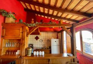 a kitchen with a wooden table and a refrigerator at La Morada Del Unicornio in Calonge +15 photos