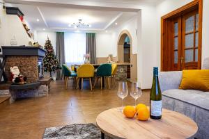 a living room with a couch and a table with wine glasses at КАТАМАН ХАУС - басейн з підігрівом in Slavske