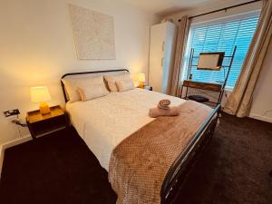 a bedroom with a large bed and a window at Spanish City View 2, Luxury Sea Front Apartment Free Onsite Parking in Whitley Bay