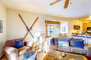 a living room with two couches and a table at Black Diamond #2B in Whitefish