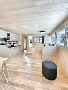 a kitchen and living room with a table and a stool at Tinyhouse Style in Obergesteln +63 photos