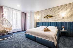 a bedroom with a bed with towels on it at ApartReserve Avtorskiy in Ivano-Frankivsk