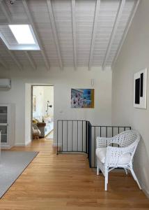 a living room with a white chair and a table at Casa dos Cortelhas in Arcos de Valdevez +26 photos