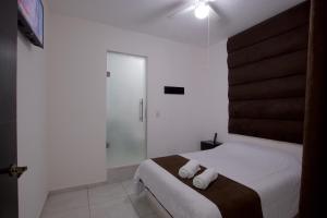 Postel nebo postele na pokoji v ubytování Hotel Villa 12 TX