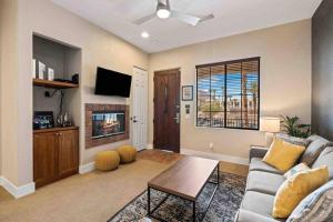 a living room with a couch and a table at Modern La Quinta Condo Old Town, Pool, Golf in La Quinta