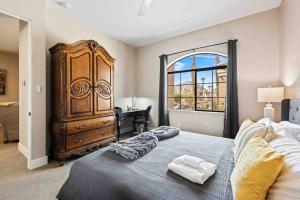 a bedroom with a large bed and a dresser at Modern La Quinta Condo Old Town, Pool, Golf in La Quinta +18 photos