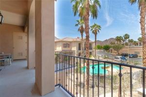 a balcony with palm trees and a swimming pool at Modern La Quinta Condo Old Town, Pool, Golf in La Quinta