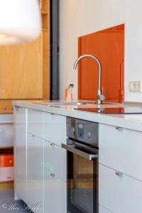 a kitchen with white cabinets and a sink at Ferienhaus ScheunenRefugio in Rot am See