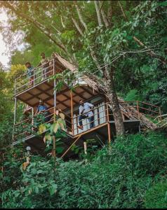 a group of people in a tree house at Sunset Valley Kerala - Where Every Evening Unveils a Perfect Sunset with Private Waterfalls in Pīrmed