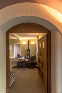 eine offene Tür zu einem Wohnzimmer mit einem Kamin in der Unterkunft Alte Schule in Herrentierbach