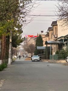 a car parked on a street in a city at Palm Hostel in Tashkent